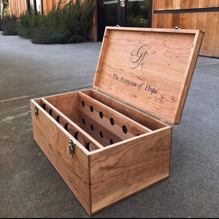 A cherry wood twelve-bottle chest with brass latches, the open lid engraved The Ascension of Hope.